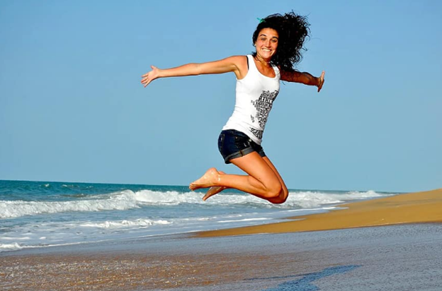 Woman jumping at beach