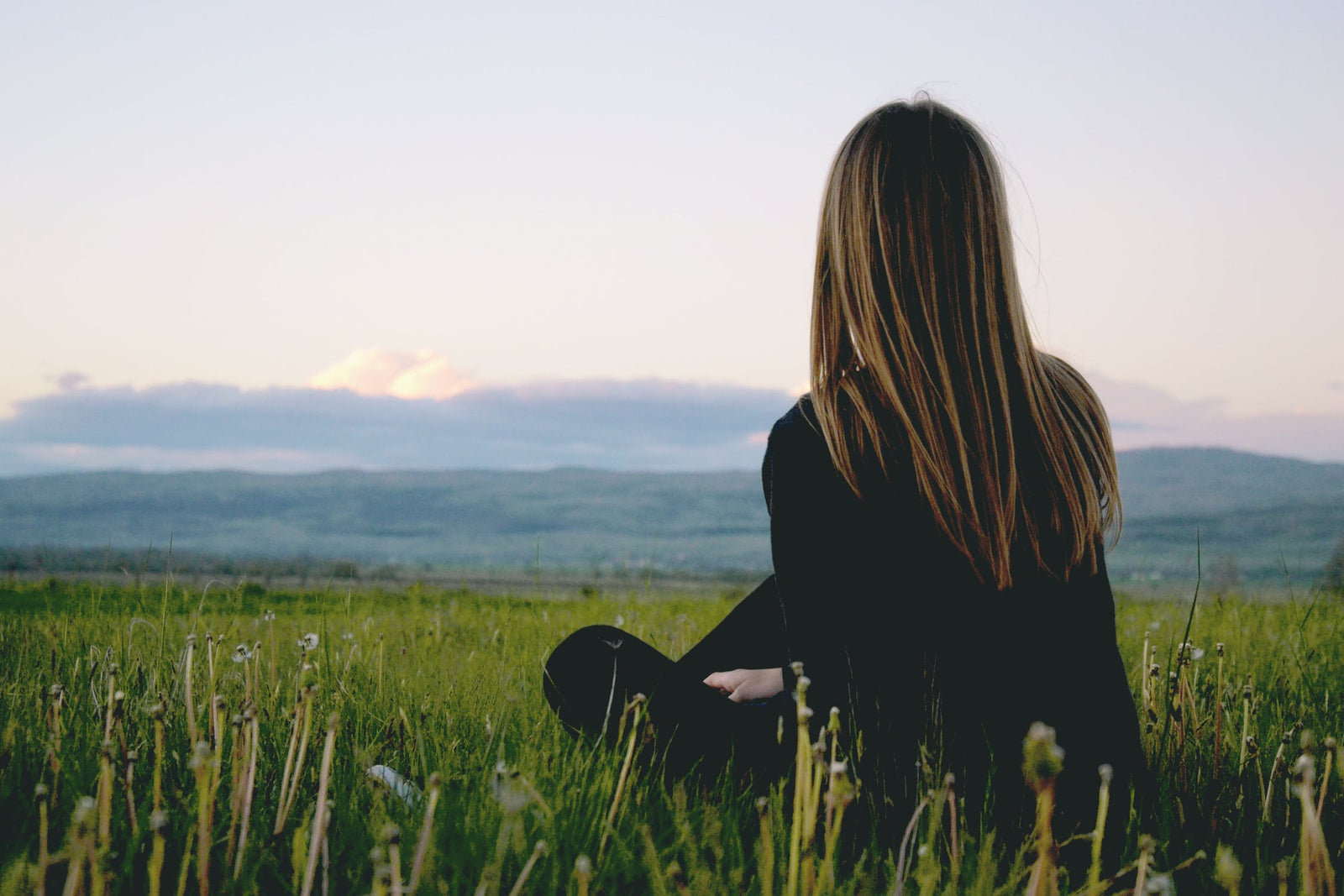 women meditating in a field