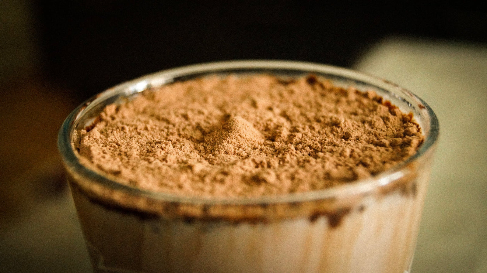 dry chocolate protein powder on glass